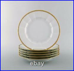 Royal Copenhagen. Six dinner plates in porcelain with gold border